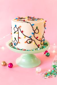 Use black licorice and Christmas light sprinkles to make a festive, easy Christmas light cake for your next holiday party! Use your favorite cake recipe.