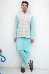 Blue Kurta With White Multi Sequins Bundi With White Pants. Consist off blue kurta, multi sequins bundi embroidered jacket, white pants.