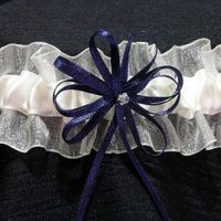 Sheer organza & silk garter with navy blue rosette. £22.50