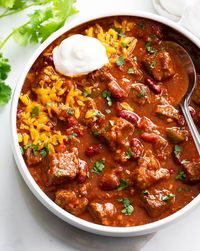 This Chili Con Carne recipe is easy to make with beef that simmers slowly in a flavorful chili sauce. Make with or without beans for a great family dinner idea and freezer meal!