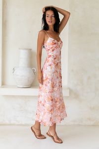 The Bed Of Roses Maxi Dress will have you dreaming of romantic getaways and summer days spent in the sun. Perfect for any occasion, this dress is the epitome of effortless chic. Get ready to be swept away to a world of endless possibilities with the Bed of Roses Maxi Dress. Style yours with loose curls and slip-on heels.  Flowy maxi dress, true to size Sweetheart neckline Thin, adjustable straps Shirred, elasticised band to back Invisible back zipper Print placement may vary Sheer overlay Lined Lightweight, polyester/rayon Cold hand wash only Model wears XS Length from shoulder to hem: 137cm on an S