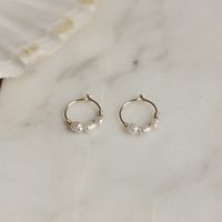 "Small hoop earrings with tiny pearl bead, each bead is different. Choose your style, 1, 2, or 3 pearls. Sold as 1 pair Material pearl: Real sweet water pearl, measurement pearl 4x2mm Diameter hoop: 10mm/0,39\" (small/average ears) or 12mm/0.47\" (bigger ears) Please measure the distance from the edge of your earlobes to the pierced hole, to choose the right hoop size! The model wears 10mm on the photo. Thickness hoop: 22 gauge/0.6mm These hoops are small and can be difficult to put on. When put