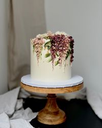 A boho buttercream wisteria cake with palette knife greenery #weddingcake