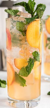 A delicious and fruity mojito recipe, this Peach Mojito is a fun twist on a classic rum cocktail - perfect for summer or backyard parties! #peach #peachmojito #mojito #cocktails #peachcocktails #summerdrinks #rum #summerparty #amandascookin