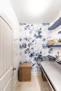 White and blue wallpaper with neutral decor for the laundry room. Such an inviting and clean space!