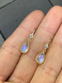 "Natural Blue Moonstone and Diamond 14K Yellow Gold Drop Earrings The diamonds are .06 carats each, VS with  F color. The moonstones are each approximately 2 carats, with a double sided cabochon cut. 1.5\" long from top to bottom  Made in solid 14K yellow gold. Custom orders welcome!"