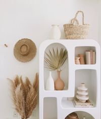 Interior Shelf Styling - Shelfie of the Isobel Urban Outfitters home Geomentic arch shaped Bookself. Styled by Relevant + Raw (@relevantraw) with DIY textured vases + HM Home vase, pampas grass and Lack of Color hat.  