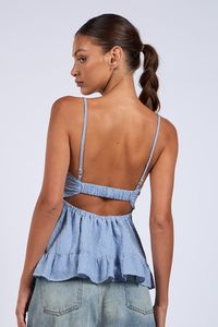 Introducing our Gracie Blue Gingham Babydoll Twist Top! Featuring blue and white gingham fabric, flattering empire waist, adjustable cami straps, a ruffle hem, and a playful cutout back. Elevate your style with this playful gingham cami babydoll top. Perfect for any occasion, with an elastic band at the back for added comfort. Style with distressed jeans for a chic casual look! DETAILS & FIT Babydoll Bodice. Adjustable Cami Straps. 100% Cotton. Lining: 100% Polyester. Hand Wash Cold. Imported. O