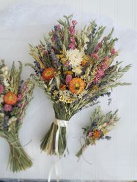 The Hippie Bouquet! One of my favorite designs! For the youthful, hippie-boho wedding! The bride's bouquet has strawflowers on both sides while the smaller bouquets are front facing. Pink and Fuschia Gomphrena, Lavender, Oats, Green Wheat, Grasses, Nigella Pods, Orange/Red and White Straw Flowers. Strawflowers are all unique.  Bouquets can come with lace wrapped stems or jute twine wrapped stems. Lace may be a little different than pictured. Boutonnieres are wrapped with hemp twine and pin on. The hairpiece is on bendable wire to hook into an up-do. Corsages tie on with hemp twine. The flower crown ties in the back with hemp twine, making it adjustable.