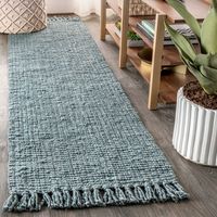 Natural jute fiber and a chunky texture make this handwoven rug a great addition to your home. The solid light gray color works almost anywhere, in both modern or traditional rooms. Fringed ends add even more texture. This rug is reversible for longer wear.