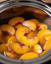 Pour a can of peaches into a slow cooker to create a timeless dessert that you'll relish spooning into