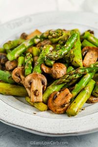 Asparagus and mushrooms are sautéed in garlic, butter, and a dash of aminos or soy sauce for an awesome low carb side dish everyone will love.