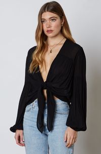 Show off your sense of style in the Gia Black Long Sleeve Tie-Front Crop Top! Gauzy black woven fabric cascades into a plunging neckline and cropped, blousy bodice with a tie-front design. Long, puffy lantern sleeves add a dramatic finishing touch to this sultry blouse. Gathered detail on hem and sleeves.