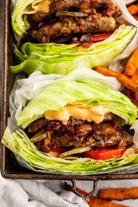 These Whole30 In N Out burgers: double double animal style are just as good as they sound and look: two thin patties brushed with mustard, loaded with pickle slices, deeply caramelized onions, a creamy sauce spiked with my Whole30 ketchup recipe, coconut aminos, and relish, all sandwiched between two perfect iceberg lettuce buns. Inspired by the West Coast favorite, these burgers are made with totally real food and are paleo. Hoorah! #whole30 #whole30recipes #innout #copycat #paleo #paleorecipes