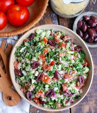 Greek Tabbouleh is a twist to classic tabbouleh using Greek ingredients. Kalamata olives, feta cheese, red onion and cucumber are paired with tomatoes, parsley, green onion and fresh herbs and topped with a light lemony dressing for a healthy salad. // acedarspoon.com #tabbouleh #Greek #vegetarian #Mediterraneandiet