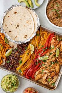 These chicken fajitas are baked in the oven on a sheet pan for a fuss free family meal that is full of flavor. Made with an easy homemade fajita seasoning.