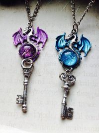 Purple Key Dragon Pendants Blue Dragon Key Fantasy Dragon Necklace Dragon Jewelry Role Playing Jewelry Fairy Tale Crystal Dragon Silver Key Necklace Dragon Lovers *We all know that Dragons love treasure, so naturally the make the best guards. Lock your treasure up and give them the key *This listing is for ONE of the dragons pictured. please select color upon purchase! *Hand painted metal dragon measures just over 1in and is painted using a high quality paint mixture, designed by myself, that wi