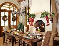 The homeowner's grandmother made the red stockings hanging above the kitchen fireplace. She made one for each family member when they were born.  She also crafted the brown felt camels on the breakfast table.