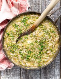 Risi e Bisi (Italian Rice & Peas) is a simple and comforting one-pot recipe. It's got a great flavour base from plenty of sweet leeks and green peas and it's creamy and rich with none of the fussiness of a risotto. In fact it's really easy to make and very family friendly.