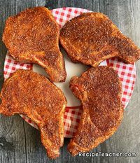 Thick, bone-in pork chops with a delicious seasoning rub, cooked to perfection on your grill.