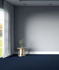 Room with navy carpet flooring and gray walls