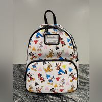 New! Disney Parks Authentic Loungefly Backpack With Ear Headband Holder Mickey Mouse And Friends You'll Enjoy Plenty Of Company Everywhere You Go With This Mini Backpack From Loungefly. Mickey Is Joined By Minnie, Goofy, Pluto, Donald And Daisy In The Colorful Allover Print On This Simulated Leather Bag That Also Includes The Fantasyland Castle. It's Perfect For Your Everyday Essentials And Trips To The Disney Parks. Simulated Leather Mini Backpack Allover Mickey And Friends Print With Fantasyla