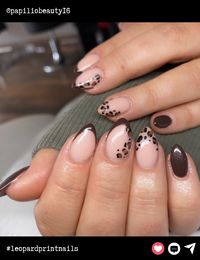 Almond-shaped nails in earthy tones bring out the ultimate chic vibes. A perfect blend of soft nude polish with dark brown leopard print and tips, this look balances elegance with a bit of sass.