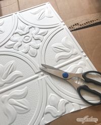 Add architectural interest and vintage style to your home with one of these easy DIY decor projects using faux tin ceiling tiles. Learn how to make oversized artwork for your mantel, a clock and a serving tray using faux tin ceiling tiles. #sponsored #tinceiling #tinceilingtiles #ceilingtiles #fauxtinceilings #vintagedecorating #antiqueceilingtiles #tin