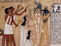 Egyptian papyrus painting of the god Anubis and four attendants preparing a mummy.