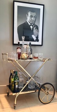 MAISON JANSEN bar cart polished brass and moody glass in brown, gold and black mirror.