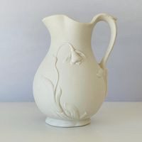 This is a flat off-white, beautifully embossed stoneware pitcher is a Bennington Museum Reproduction. It is an elegant small pitcher or creamer. It is the Bennington Museum Jonquil Bisque design with embossed draping flowers around it. It is 5-3/4" tall. Marked on the underside, Bennington Museum Reproduction, Age unknown. Very good quality and condition. No chips, cracks or crazing. Quality and condition are suitable for gift giving. This item is preowned and shows little use or ware. Please be sure to view all photos as they are part of the description and can be the best descriptors. See photos for approximate measurement. Please browse the rest of our shop for many vintage items for home and life. If you purchase multiple items and I will refund any shipping overage charges. I ship all