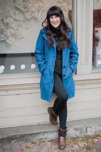 A woman standing in front of a building