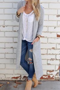 25 Stylish Outfits With Cuffed Jeans: Woman wearing ripped and cuffed skinny jeans with a white T-shirt and long grey cardigan, together with beige ankle booties