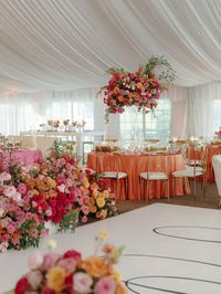 Imagine a magical wedding reception bursting with vibrant colors like hot pink and orange, adorned with luxurious flowers and sparkling gold accents. Picture elegant gold chairs amidst a sea of opulent decorations. And don't forget the pièce de résistance - a floral-dripped sweetheart table fit for royalty! Plus, check out fun lounge chair ideas that add extra charm to the celebration. Hot pink wedding decor. Luxury wedding florals.