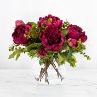 This gorgeous real touch peony centerpiece flower arrangement includes 5 fuchsia pink peony flowers with peony flower buds and a splash of green berries. Handcrafted for lasting beauty, this elegant centerpiece arrangement is perfect for a dining room table, living room, coffee table, or classy foyer. #luxuryhomedecor #floralcenterpiece #floralhomedecor #peonycentepriece #silkflowerarrangement