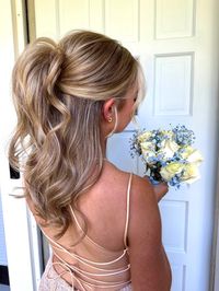 a half up half down prom hair inspiration. This style is super easy- after your hair is in curls use an elastic to create a half up pony tail, hold the pony tail up towards the crown of your head and then secure a bobby pin in underneath. after this tease the pony tail hiding the elastic/bobby pin and give an illusion of a voluminous half up pony.