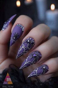 Add a touch of glamour to your Halloween look with these dazzling spider web nails! Purple matte finish with silver spider and rhinestone details create a chic and spooky vibe. Perfect for classy Halloween nails. Explore more at nailhow.com. Save this pin for your next nail design!