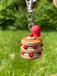 💖Details💖 This is a strawberry and cream pancake handmade out of polymer clay and detailed with soft pastels. It even comes with a  little clay strawberry charm attached! Both items are finished with a satin glaze. Afterwards, they are attached with a metal chain and swivel snap hook. 💖Size💖 ⭐️Height of pancakes - 1.25 inches approx.  ⭐️Height of whole keychain - 3 inches approx.  ⭐️Height of strawberry charm - 0.75 inch approx. 💖Care💖 For light cleaning, use a soft, damp cloth and gently wipe the surface. These are varnished with a satin glaze, so please do not use alcohol on them.  💖Made To Order💖 Because each keychain is made to order, I do not have any readily available to send out. Please allow 5-7 business days for the keychain to be made. Each item is handmade by me, from sc