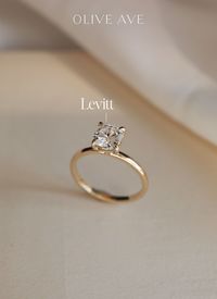 14K Yellow Gold | Levitt features an elegant cushion center stone set with claw prongs in a traditional solitaire setting on a half round shank.