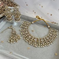 Beautifully flexible Antique Gold intricate necklace set scattered with dazzling crystals and glass bead finishing. Comes with matching statement jhumka earrings (approx 3 inch length x 1.25 inch width) and matching tikka ( pendant part 2.5 inch length x 1.5 inch width) Ready to ship as seen with gift box!