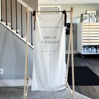 Every sign is crafted with care and attention to detail. Our linen fabric sign makes a unique and stunning statement. Limited quantities available, make sure to pre-order before they're sold out! *For reference the cover photo is our 24x51 size Add any design from our website to this sign, excludes seating charts Size and alignment may be altered to better fit the text you've provided Last bar sign photo is not ours, just as inspiration until we take photos (Size 18x35) All lettering is ink printed on premium white fabric. The linen edges are frayed by hand and feature a sewn pocket at the top for easy hanging. Or, if you decide not to use the pocket you can use the two tiny holes at the top to attach a ribbon and hang however you'd like. See below for more on customizable options, and how