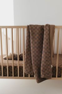 Wrap your little one in cozy comfort with our Faded Brown Checker Muslin Swaddle! The faded brown checker board design adds a touch of style to this soft and breathable swaddle. Keep your baby snug and warm while also showcasing your love for unique prints. 100% muslin cottonIncludes one single layer muslin cotton swaddleDimensions : 47x47Care Instructions : Machine wash with like colorsTumble dry on low or hang dry