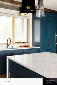 Bold blue cabinets and natural wood tones are a perfect pairing for the sleek finish of Cambria Gladstone quartz countertops. Together, they give this kitchen design an inviting and warm feeling with a touch of bold elegance. 

Designer: Renae Keller Interior Design  Photographer: Chelsie Lopez Production