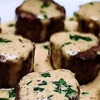 Chef zouheir on Instagram: "🔥Sizzling Garlic Butter Steak Bites with Creamy Parmesan Sauce 🧀

Ingredients:
- 1 pound sirloin steak, cut into bite-sized pieces
- 2 tablespoons olive oil
- 4 tablespoons unsalted butter
- 4 cloves garlic, minced
- 1 cup heavy cream
- 1/2 cup grated Parmesan cheese
- 1 teaspoon dried thyme (optional)
- 1 teaspoon garlic powder
- Salt and pepper
- Fresh parsley, chopped

Directions:
1. Season & Sear Steak: Season steak bites with salt and pepper. Sear in olive oil until browned.
2. Make Garlic Butter: Melt butter, sauté garlic, and thyme.
3. Create Creamy Parmesan Sauce: Add cream, Parmesan, garlic powder, salt, and pepper.
4. Combine & Heat: Toss steak bites in the creamy sauce, heat through.
5. Garnish & Serve: Top with fresh parsley and enjoy immediately.
