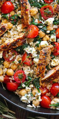 Greek Chicken with Lemon Rice, Chickpeas, Spinach, Grape Tomatoes, and Feta Cheese. 30 Minute One-Pan Meal.  It's healthy, gluten-free, protein-rich, and fiber-rich, and can be easily made dairy-free.