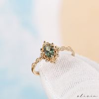 "Discover the timeless allure of our Vintage Green Sapphire Engagement Ring, a true embodiment of elegance and vintage charm. Crafted in exquisite 14K and 18k options rose, white, yellow gold, this dainty piece features a brilliant green sapphire, resonating with September's birthstone. Adorned with diamonds and showcasing vintage style, this fine estate ring is designed for a woman seeking both sophistication and a touch of nostalgia. F E A T U R E S 💎 D I A M O N D Carat: 0.03 Quality: VS1 Color: F-G Cut: Round 💠 G E M S T O N E Type: Green Sapphire Carat: 0.48 Cut: Oval 🌟 M A T E R I A L Gold: Available in 14K and 18K Options Color: Choices of White, Rose, or Yellow 🎁 Extra Touch: As a testament to our dedication to exceptional customer service, each purchase is accompanied by a com