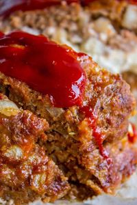 Cream Cheese Stuffed Meatloaf from The Food Charlatan. Is anybody gonna turn down a good old fashioned meatloaf? I mean come on, it's a classic! This one is moist and tender and STUFFED WITH CREAM CHEESE. Oh yeah. Stuffed meatloaf > regular dry meatloaf. #meatloaf #comfortfood #ketchup #makeahead #stuffed #classic #lowcarb #sauce #traditional #best #easy