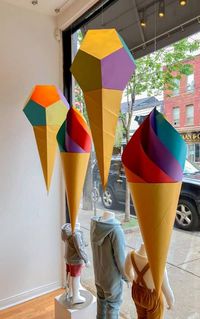 3D paper art ice cream cones in store window created by Florencia Alba who is in the Artist Spotlight on the All Things Paper blog