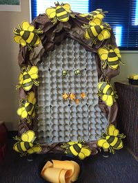 Prehschool-Mobile bee-hive, 2016 version... created with egg cartons mounted to a picture frame box, then attached to an easel/white board. Small rubber bees, crumbled paper and yarn puff balls are available to create the hive.