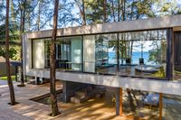 Floor-to-ceiling sliding glass doors with private balcony and sea views